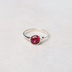 A lovely faceted gemstone ring adds some sparkle & color! Wear alone or stack with others. This synthetic ruby version is a perfect gift for a July birthstone. Sterling Silver 6mm Round Bezel Set Synthetic Ruby Classic Red Birthstone Stackable Rings, Red Birthstone Stackable Rings, Stackable Ruby Birthstone Rings, Stackable Ruby Birthstone Rings With Round Band, Ruby Birthstone Ring With Bezel Setting, Adjustable Red Birthstone Ring, Red Round Ring For Everyday, Everyday Red Round Ring, Adjustable Ruby Ring With Bezel Setting