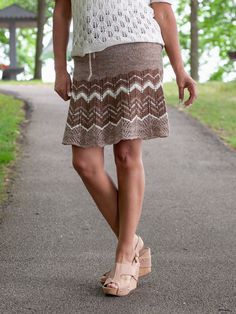 A flirty drawstring skirt in 9 sizes (XS/S/M/L/1X/2X/3X/4X/5X) to wear as a stylish alternative to shorts for summer fun. Worked in the round from waist to hem in widening panels, the fabric is solid through the hip, with openwork patterning to the knee. Stripe it for eye-catching flare or solid for a more elegant look