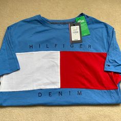 Tommy Hilfiger Original T-Shirt Casual Blue Tops With Flag Print, Red Casual T-shirt With Flag Print, Casual Red T-shirt With Flag Print, Blue Cotton Tops With Flag Print, Casual Crew Neck T-shirt With Flag Print, Summer Blue Shirt With Flag Print, Blue Flag Print Summer Shirt, Casual Cotton Shirt With Flag Print, Blue Flag Print Short Sleeve Shirt