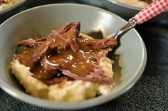 two bowls filled with mashed potatoes covered in gravy and chocolate sauces