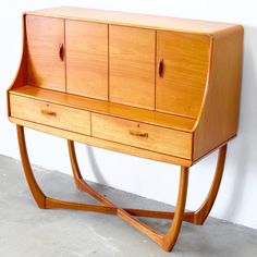 a wooden desk with two drawers on it