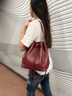 This wonderful leather bucket bag, expertly crafted in my workshop, promises to be the perfect companion for women who appreciate elegance and functionality in a single accessory. Each bag is meticulously handmade, adding a unique touch and heightened focus on quality. Exterior of the Bag: The bag is designed in a versatile bucket style, combining modern design with functionality. Your hands will love the touch of the high-quality leather, and the short handles, elegant metal ring attachment, an Leather Bucket Shoulder Bag Gift, Leather Bucket Shape Shoulder Bag As Gift, Leather Bucket Shape Shoulder Bag For Gift, Burgundy Bucket Shoulder Bag For Everyday, Elegant Burgundy Leather Bucket Bag, Leather Tote Bucket Bag For Gift, Leather Tote Bucket Bag As Gift, Leather Bucket Bag As Gift, Gift Leather Handles Bucket Bag