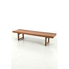 a wooden bench sitting on top of a white floor