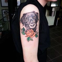 a woman with a dog tattoo on her arm and rose in front of her shoulder