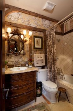 a bathroom with a sink, toilet and bathtub in the corner next to a mirror