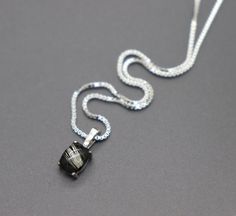 "This mourning jewelry keepsake necklace is made from 925 sterling silver. The dainty pendant measures 14mm tall and 6mm across and hangs from a sterling box chain. Your preferred length of chain can be chosen from the drop-down menu. A handmade domed \"stone\" is carefully created around your lock of hair or animal fur. I layer and shape my handmade stones methodically for maximum magnification of the hair provided. We have a wide assortment of colors that can be chosen for the background, view Sterling Silver White Gold Necklace For Memorial, Adjustable Sterling Silver Memorial Jewelry, Silver Square Pendant Jewelry For Memorial, Minimalist Sterling Silver Memorial Necklace, Elegant Sterling Silver Jewelry For Memorial, Elegant Pendant Jewelry For Memorial, Elegant Memorial Pendant Necklace, Elegant Adjustable Memorial Necklaces, Elegant Adjustable Necklace For Memorial