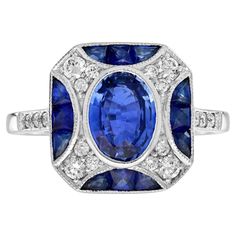 An impressive antique Art Deco inspired 1.45 carat oval blue sapphire with diamond accent. The ring is crafted in 118k white gold and is currently a finger size 7. Low set, comfortable and unique this ring is outstanding. This stunning ring would make the perfect engagement ring or a great additional to any collection. Ring Information Style: Art-deco Metal: 18K White Gold Total weight: 4.90 g. (approx. total weight) Ring size: US 7 (resizable) Center Gemstone(s) Type: Ceylon Sapphire Shape: Oval Size: 8 x 6 mm. Number: 1 Weight: 1.45 Carat (approx. total weight) Accent Gemstone(s) Type: Blue Sapphire Shape: French Cut Size: 2.5 mm. Number: 12 Weight: 1.20 Carat (approx. total weight) Shoulder Gemstones Type: Diamond Shape: Round Average Color: H Average Clarity: SI Size: 1.3 - 2 mm. Numbe