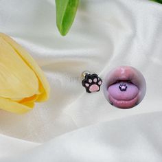 a close up of a flower and a fake animal's paw