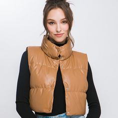 Add a touch of edgy style to your casual outfits with our Faux Leather Puffer Vest. This trendy puffer vest is perfect for layering over your favorite tops. This is a versatile and must-have addition to your casual wardrobe, perfect for staying warm and fashionable during cooler days.Model is 5' 7" wearing a size small. Care Instruction: Machine wash cold, gentle cycle, tumble dry low. Fabric Contents: 100% Polyurethane Non-stretch fabric Non-sheer fabric Size Measurement (inch): S: 14.0 (Bust), Sleeveless Fall Outerwear For Streetwear, Sleeveless Outerwear For Fall Streetwear, Winter Streetwear Vest In Solid Color, Trendy Cold Weather Vest Outerwear, Winter Streetwear Vest, Trendy Cold Weather Vest, Casual Brown Winter Vest, Casual Brown Vest For Winter, Trendy Vest For Cold Weather