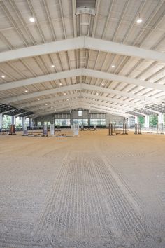 the inside of an empty building with lots of windows and lights on top of it