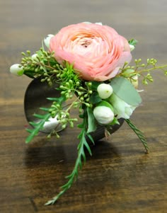 a bouquet of flowers sitting on top of a wooden table