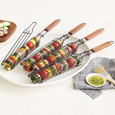 several skewers filled with different types of food on top of a white plate