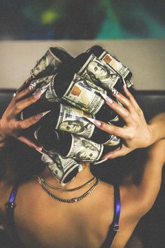 a woman with her hands on top of money