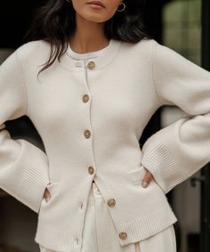 Cooper Cardigan Warm Ivory Featuring a structured hourglass silhouette and a very slight bell sleeve, this chic knit is unlike anything we’ve done before. Ultra-soft wool cashmere and a classic shape are easily styled with everything from wide-leg trousers to your favorite skirt. 70% wool, 30% cashmere. Made in China. Fitted button-down cardigan. | 70% wool, 30% cashmere. Made in China of Peruvian yarn. Fitted button-down cardigan. Dry clean. Fits true to size. | Jenni Kayne Women's Cooper Cardi Structured Cardigan, Sweaters Style, Clean Fits, Winter Knitwear, Clothing Wishlist, The Cardigans, Hourglass Silhouette, Casual Chique, Trendy Sweaters