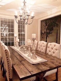 a dining room table with chairs and a chandelier