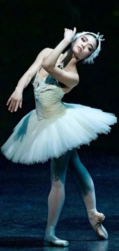 a ballerina in white tutu and ballet shoes