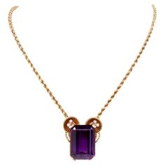 This conspicuous Retro pendant necklace is an authentic piece of jewelry designed and manufactured by the Swiss Horologists & Jewelers Gueblin. This opulent amethyst and pearl pendant exposes a magnificent intense purple color Rectangular cut amethyst approx. 73.35 carats enriched with 8 enchanting seed pearls 2mm t0 5mm., the upper ones positioned within artfully designed basket shape settings with twisted rope design yellow gold edges adding to the shining effect of gold. The undercarriage of the pendant bears the signature of Gueblin, the purity mark '750' and the Ref. # 261866. The integrated twisted rope design chain measures 20.5 inches long (adjustable to 17.5 inches by virtue of additional spring & ring). This captivating designer pendant necklace is in pristine condition. Gueblin Mafia 2, Goddess Jewelry, Artfully Designed, Athena Goddess, Rope Design, Seed Pearl, Drop Necklace, Gold Pendant Necklace, Pearl Pendant