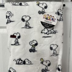 a white blanket with black and white cartoon characters on it, hanging from a hook