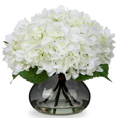 a vase filled with white flowers on top of a table