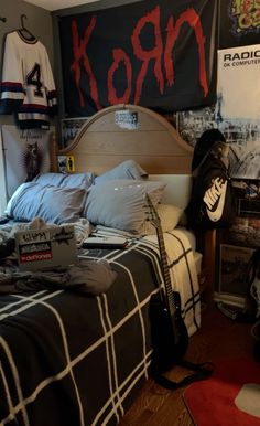 a room with a bed, hockey jersey and posters on the wall next to it