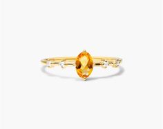 14K Yellow Gold Citrine Oval and Diamond Birthstone Ring. This ring pairs vintage style with royal elegance. Wear this classic ring and add luxury everyday and on special occassions. Elegant Yellow Topaz Ring With Gemstone Accents, Classic Yellow Gold Topaz Ring With Gemstone Accents, Classic Gold Topaz Ring With Diamond Accents, Classic Rings With Oval Cabochon Gemstone Accents, Elegant Yellow Oval Birthstone Ring, Elegant Citrine Diamond Ring With Accents, Elegant Citrine Rings For Formal Occasions, Elegant Oval Topaz Ring With Diamond Accents, Elegant Marquise Cut Yellow Gold Topaz Ring