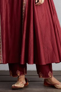 Garnet red flared long kurta with all-over aari worked motifs and side panels. Comes with handwoven chanderi pants and scallop border dupatta.
Component: 3
Embroidered
Neckline: Round
Sleeve Length: Full
Fabric: Kurta and Pant: Handwoven Chanderi and Cotton Voile; Dupatta: Handwoven Chanderi
Color: Red
Side panels
Churidar sleeves
Scallop cutwork - Aza Fashions Festive Anarkali Tussar Silk Palazzo Set, Anarkali Tussar Silk Palazzo Set For Festive Occasions, Tussar Silk Anarkali Set With Cutdana, Unstitched Red Sharara With Sheer Dupatta, Designer Wear Palazzo Set With Traditional Drape, Elegant Red Churidar With Sheer Dupatta, Festive Red Ankle-length Kurta, Unstitched Red Anarkali Set With Dabka Work, Designer Red Churidar With Sheer Dupatta