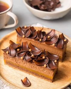 two slices of chocolate cake on a wooden plate