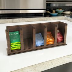 three wooden boxes with tea bags in them on a counter top next to an oven