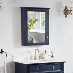 a bathroom with a sink, mirror and towel rack on the wall next to it