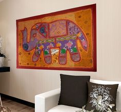 an elephant tapestry hanging on the wall in a living room