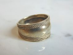 FOR SALE IS THIS WONDERFUL WOMENS VINTAGE ESTATE STERLING SILVER MODERNIST RING. THE RING WEIGHS 6.2g, AND IS A SIZE 7.75. ANY QUESTIONS PLEASE DO NOT HESITATE TO ASK. BE SURE TO CHECK OUT SOME OF MY OTHER GREAT ITEMS UP FOR SALE. THANK YOU. IF THERE ARE ANY ISSUES PLEASE CONTACT US, WE'RE ALWAYS HAPPY TO TRY TO HELP YOU OUT AS BEST AS WE CAN. Vintage Engraved Wide Band Ring For Wedding, Vintage Wide Band Engraved Wedding Ring, Vintage Engraved Wide Band Wedding Ring, Vintage Hallmarked Wide Band Ring For Formal Occasions, Vintage Gold Wide Band Ring, Vintage Silver Wide Band Ring For Formal Occasions, Silver Vintage Wide Band Ring For Formal Occasions, Vintage Wide Band Hallmarked Rings, Vintage Hallmarked Wide Band Ring