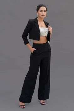 Black crepe short blazer with metal fringed hemline. Comes with high-waisted pant and a modal padded bustier with diamante stones and crystals hand embroidery. - Aza Fashions Elegant Cropped Bottoms For Formal Wear, Elegant Cropped Bottoms For Formal Occasions, Elegant Formal Cropped Bottoms, Chic Cropped Pants For Evening, Chic Formal Cropped Pants, Chic Cropped Formal Pants, Elegant Cropped Pantsuit For Formal Occasions, Elegant Cropped Pantsuit For Formal Events, Elegant Cropped Pantsuit For Office