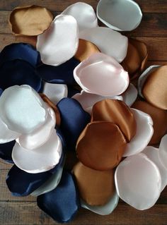 there are many different colored hats on the wooden floor, one is white and one is blue