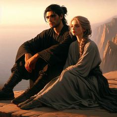 a man and woman sitting on top of a cliff