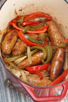 sausages and peppers are cooked in a pot