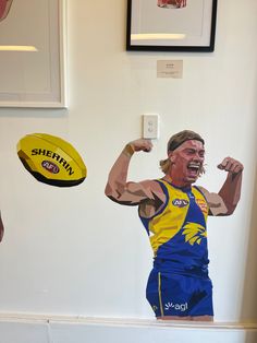 a man in blue and yellow uniform holding a frisbee