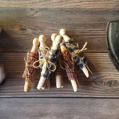 three wooden pegs are tied up to each other on a wood table next to an old shoe