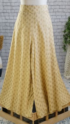 **Product color may have slight variations due to surrounding light** PRODUCT DETAILS A pair of Beige printed woven flared fit Palazzos, opaque, 1 pockets, and slip-on closure Size & Fit Small: 30 inches (expandable upto 36 inches) Medium: 32 inches (expands upto 38 inches) Large: 34 inches (expands upto 40 inches) X-Large: 36 inches (expands upto 42 inches) XX-Large: 38 inches (expands upto 44 inches) Length: 38 inches Material & Care Liva Hand-wash Specifications Occasion Ethnic Fit Fl Fitted Ankle-length Bottoms, Traditional Fitted Bottoms For Wedding, Fitted Floor-length Party Bottoms, Fitted Wedding Trouser Set, Fitted Pants For Festive Wedding Occasion, Fitted Pants For Wedding And Festive Occasions, Fitted Wedding Trousers Set, Festive Fitted Pants For Wedding, Traditional Fitted Wedding Bottoms