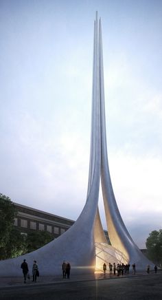 people are walking around in front of a tall building that has a very long pointed spire