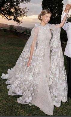 a man and woman dressed in wedding gowns