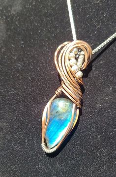 Enhance your jewelry collection with this exquisite handmade wire-wrapped pendant, featuring a mesmerizing blue Labradorite gemstone. The enchanting hues of the Labradorite are beautifully complemented by the warm tones of copper and the elegance of sterling silver, making this pendant a stunning piece of wearable art. 💍Key Features:  🔴Gemstone: Genuine Labradorite 🔴Materials: Copper and 92.5 Sterling Silver 🔴Finish: Hand-oxidized and polished for an antiqued look 🔴Design: Unique wire wrap Wire Wrapping Techniques, Handmade Wire Wrapped, Blue Labradorite, Handmade Wire, Labradorite Pendant, Unique Pendant, Silver Pieces, Wire Wrapped Pendant, Sterling Silver Necklaces