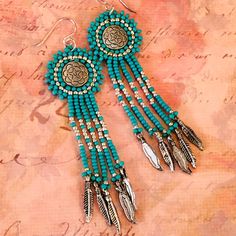 Turquoise and Silver Native American inspired seed bead feather fringe earrings Bali silver coin beads surrounded by a handbeaded bezel made with 11/0 metallic silver and turquoise seedbeads with colorful fringe finished with silvers feathers. The french hook earwires are sterling silver. These very lightweight earrings are made with turquoise colored seed beads. They are the same on both sides and look absolutely gorgeous from the front and back. Great for daywear and stunning for the night out Bohemian Round Beaded Earrings With Silver Beads, Bohemian Silver Jewelry With Beaded Fringe, Silver Jewelry With Beaded Fringe For Festivals, Silver Bohemian Jewelry With Beaded Fringe, Turquoise Earrings With Beaded Fringe, Artisan Turquoise Beaded Fringe Earrings, Bohemian Turquoise Beaded Fringe Earrings, Elegant Turquoise Beaded Earrings Nickel-free, Earrings Bali