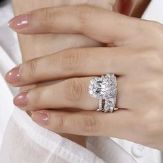 a woman's hand with a diamond ring on it