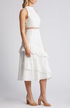 A breezy eyelet dress offers winsome charm with an embroidered waist cutout and cascading, asymmetric ruffles in an A-line silhouette. 45" to 50" center front length (size 8) Mock neck Sleeveless, with cutaway shoulders Lined 100% polyester Dry clean Imported Summer Dresses With Broderie Anglaise And Tiered Skirt, Summer Broderie Anglaise Tiered Skirt Dresses, Summer Tiered Broderie Anglaise Dresses, Summer Broderie Anglaise Tiered Dress, Sleeveless Eyelet Dress For Spring, Sleeveless Fitted Midi Dress With Broderie Anglaise, Fitted Sleeveless Midi Dress With Broderie Anglaise, White Cutwork Dress For Summer, Feminine Sleeveless Midi Dress With Broderie Anglaise