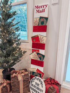 a christmas tree and presents under a merry mail sign