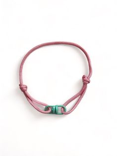 Discover the perfect accessory to complement your laid-back style Unisex Adjustable Cord Bracelet with contrasting coloured metal swivel connector. The bracelet features a durable, high-quality genuince paracord construction. The materials are meticulously selected to ensure long-lasting wear, making it a robust companion for your adventures or daily activities. One of the standout features of this bracelet is its adjustability. The sliding knot design provides flexibility in size, making it easy to get the perfect fit. Whether you prefer a snug or relaxed fit, this bracelet adjusts to your preference, making it comfortable to wear all day long. Ideal for wearing everyday or adding a unique touch to formal wear, this cord bracelet transitions effortlessly from day to night. Its versatile d Affordable Green Bracelets With Adjustable Cord, Green Bracelets With Adjustable Cord, Adjustable Durable Bracelet For Outdoor, Adjustable Durable Red Bracelets, Durable Adjustable Bracelet For Outdoor, Adjustable Everyday Jewelry Bracelet, Adjustable Green Bracelets For Outdoor, Adjustable Nylon Cord Braided Bracelets For Outdoor, Everyday Nylon Cord Bracelet