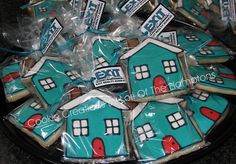 decorated cookies in the shape of houses are on display