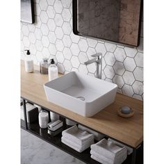 a bathroom sink sitting on top of a wooden counter