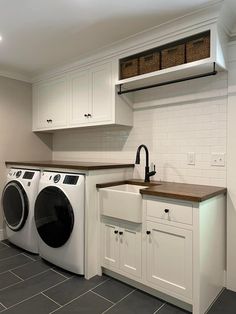 a washer and dryer sitting in a kitchen next to each other on the floor