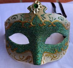 This new decorative Venetian style masquerade mask is green and gold glitter design. This masquerade mask is ribbon tie concept to create a comfortable fit and great to reuse if needed. Masquerade mask Measurements:  9" inches across 4" inches high This beautiful masquerade mask is great for a birthday party, wedding or Halloween costume party. We do our best to take live, clear and as many pictures as possible to guarantee what you see is what you will receive. Any issues with the purchased pro Mask Venice, Mask Masquerade Ball, Theatrical Costumes, Gold Halloween, Mask Venetian, Masquerade Ball Mask, Venice Mask, Ball Mask, Party Mask